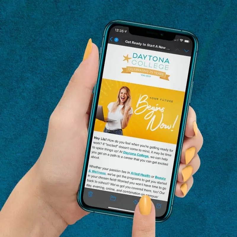 Young woman with tangerine orange fingernails holding teal iPhone displaying an email from Daytona College